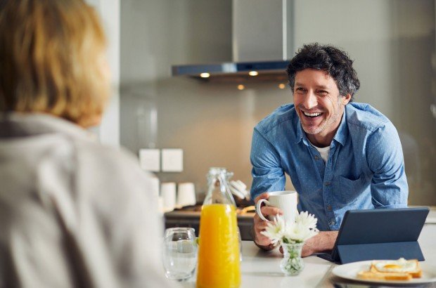 Smiling man enjoys a conversation after applying for an Expat Buy to Let mortgage on behalf of his client with the Marsden Intermediaries.