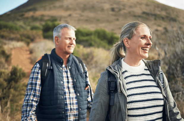 A Mature couple walking in the countryside after applying for a Lending into Retirement mortgage with Marsden Intermediaries