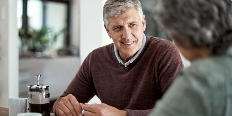 Man and woman sit at home discussing life planning