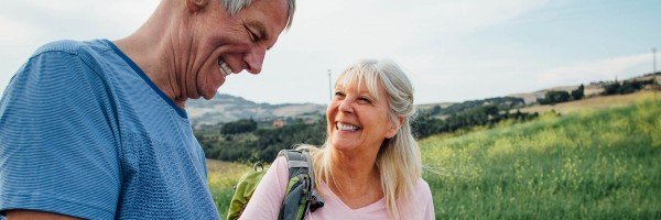 Couple walking and smiling outdoors