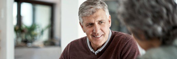 Man and woman sit at home discussing life planning