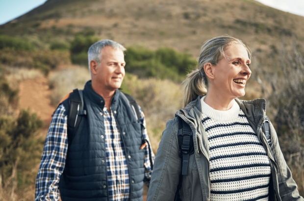 Couple approaching retirement enjoy a walk in the countryside after securing a Lending into Retirement mortgage with Marsden Building Society