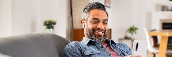 Young woman sat in an armchair smiling to represent Expat Residential case study