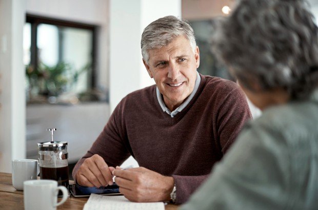 Mortgage broker talking with client applying for a Retirement Interest Only mortgage with the Marsden Intermediaries.