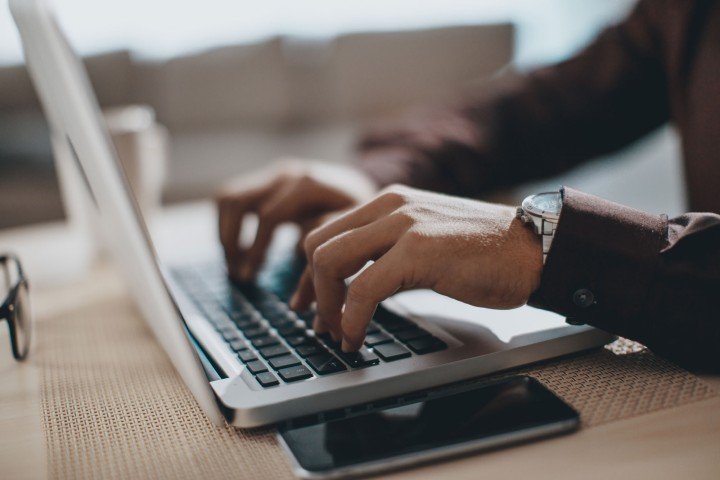 Man sits at a laptop using Affordability Calculators provided by Marsden